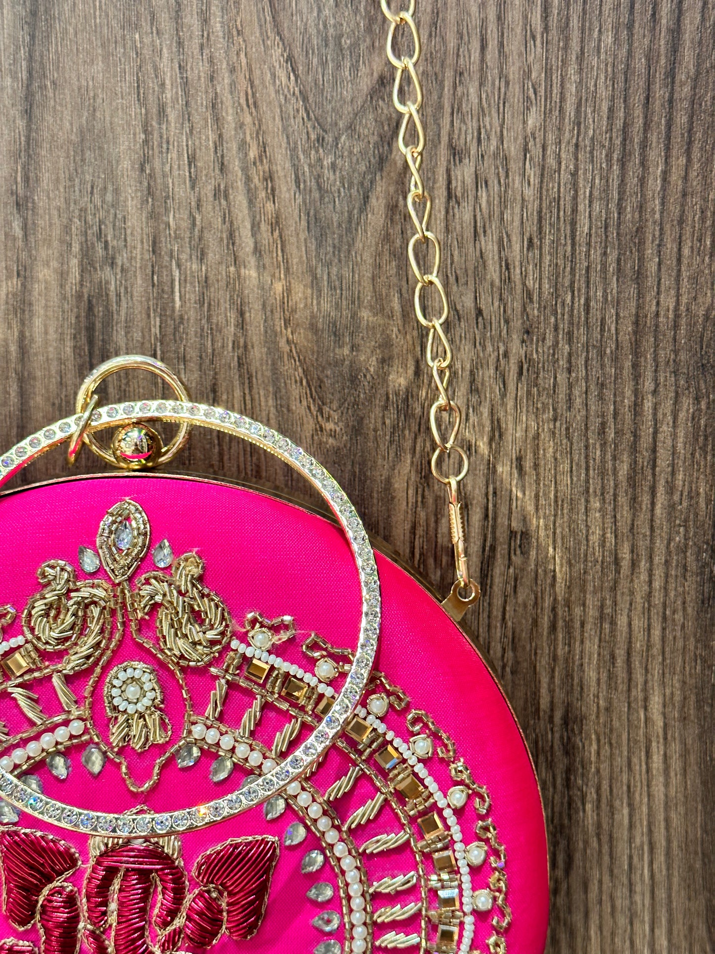 Shocking Pink Ganesha Embroidered Diamond Studded Wristlet with Gold Sling Chain