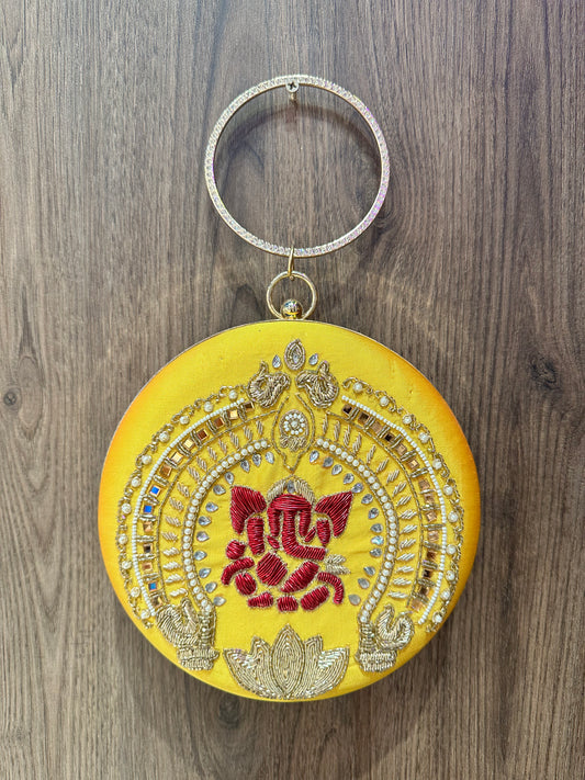Yellow Ganesha Embroidered Diamond Studded Wristlet with Gold Sling Chain