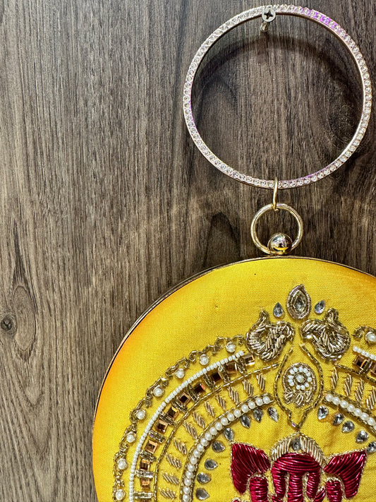 Yellow Ganesha Embroidered Diamond Studded Wristlet with Gold Sling Chain